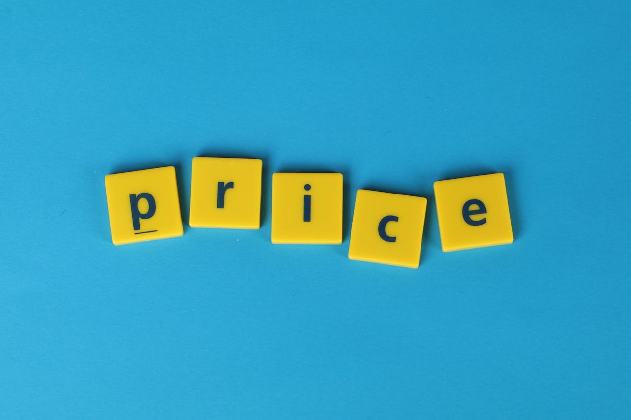 Yellow letter tiles spell the word price against a vibrant blue backdrop, ideal for business concepts.